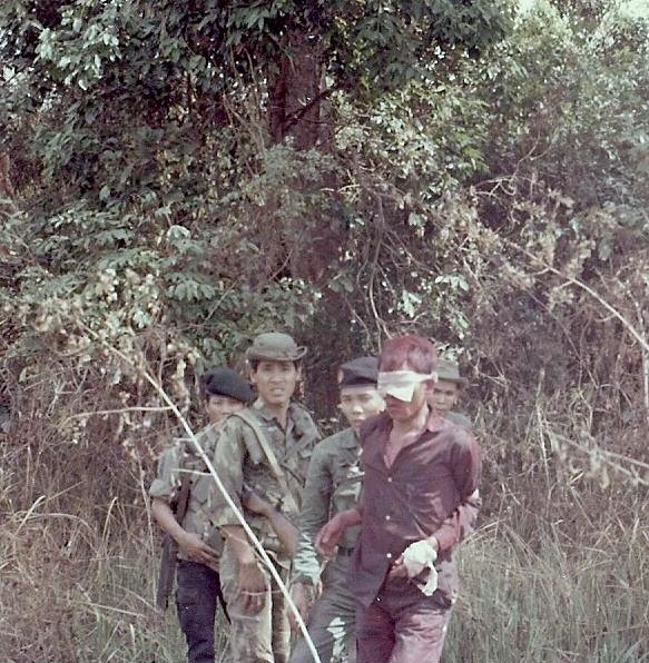 Captured soldier covered with red smoke